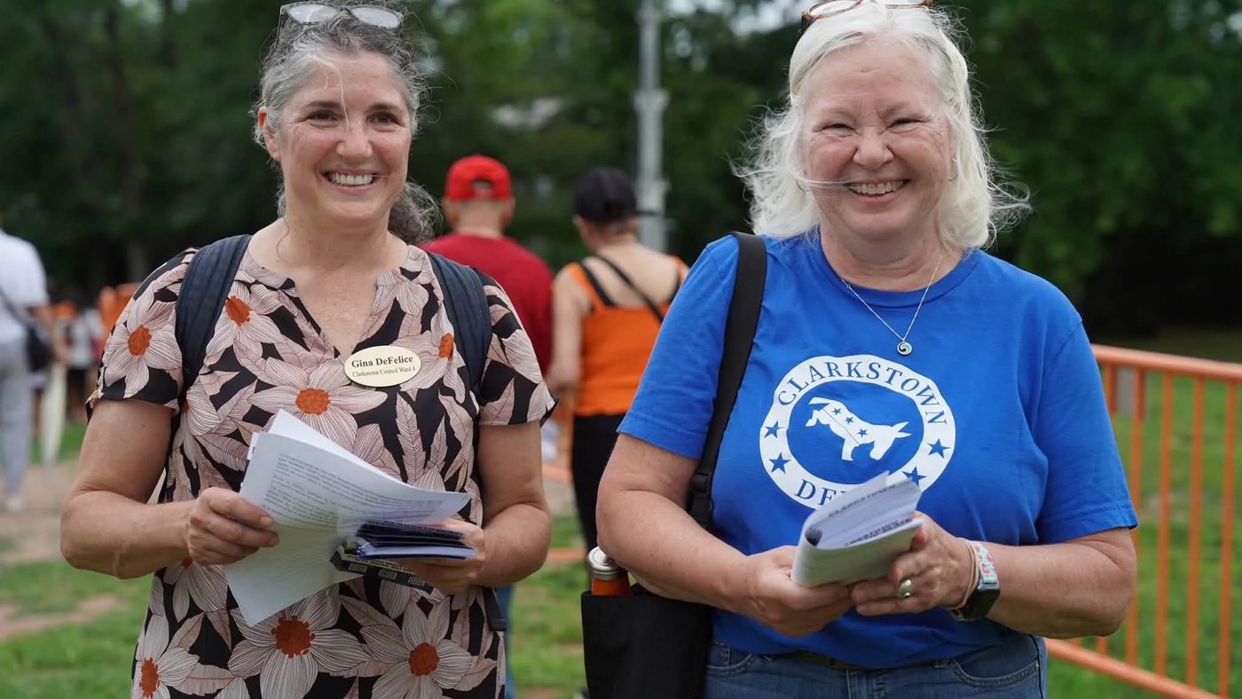 Gina DeFelice out canvassing with a Clarkstown Democrats volunteer, both carrying literature