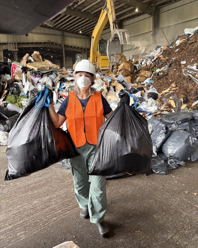 Gina DeFelice in a hard hat and high-visibility vest at a county waste transfer station